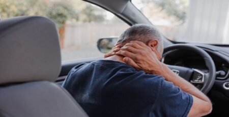 Middle-aged man with neck pain Inside the Car